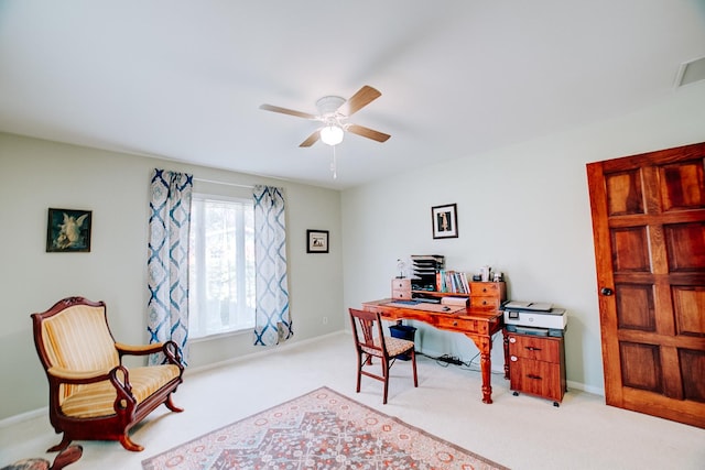 carpeted office space featuring visible vents, baseboards, and ceiling fan