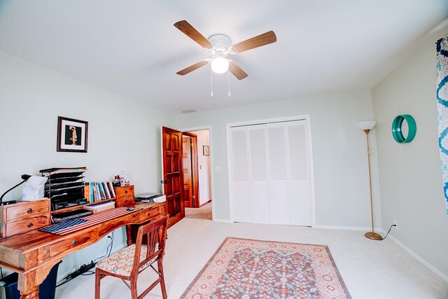 office area featuring baseboards, carpet floors, and ceiling fan