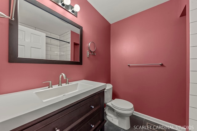 full bathroom featuring tile patterned flooring, baseboards, vanity, and toilet