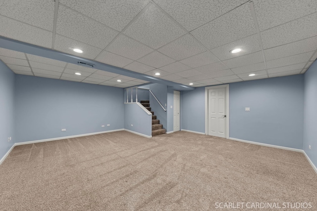 finished basement featuring baseboards, visible vents, stairway, carpet floors, and recessed lighting