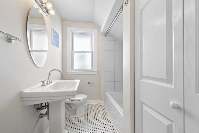 bathroom featuring baseboards, vaulted ceiling, and toilet