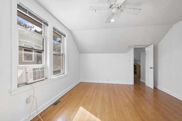 bonus room with baseboards, visible vents, wood finished floors, vaulted ceiling, and cooling unit