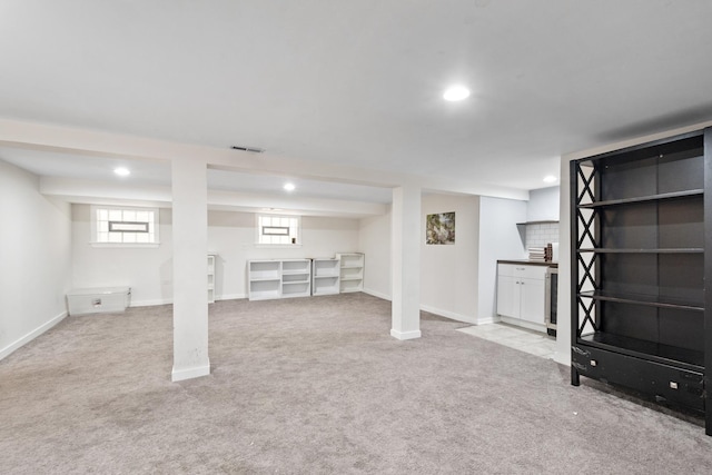 below grade area featuring visible vents, baseboards, carpet flooring, and recessed lighting