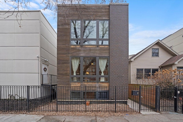 view of front of house with a fenced front yard and a gate