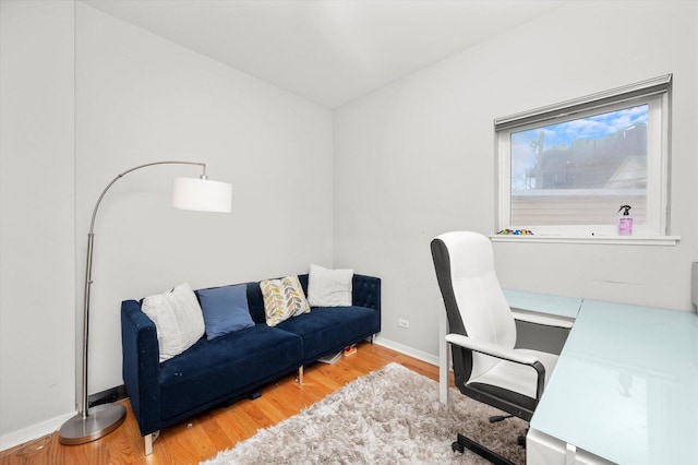 office space featuring baseboards and wood finished floors