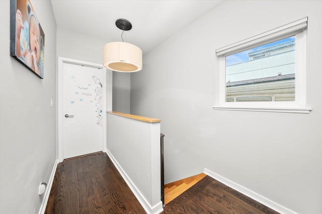 doorway to outside with baseboards and wood finished floors