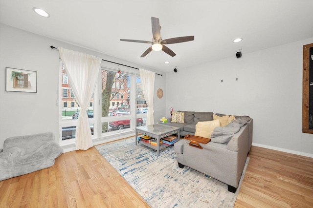 living room featuring baseboards, ceiling fan, wood finished floors, and recessed lighting