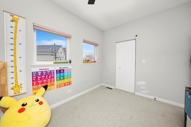 game room with carpet floors, visible vents, baseboards, and a ceiling fan