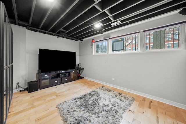 living area with visible vents, baseboards, and wood finished floors