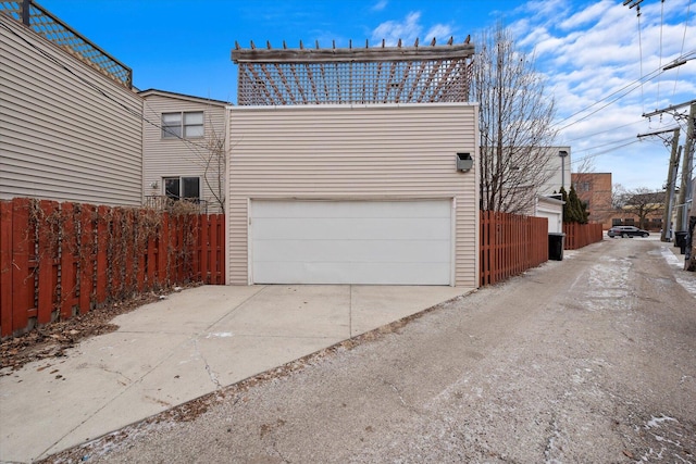 view of property exterior featuring a garage and fence