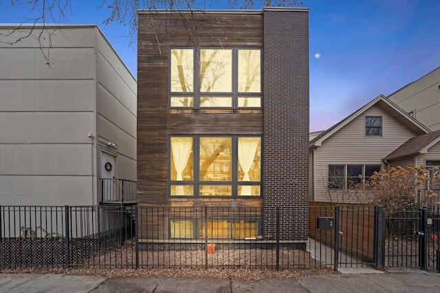 contemporary house with a fenced front yard and a gate