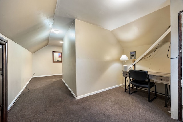 office space with carpet floors, baseboards, and vaulted ceiling