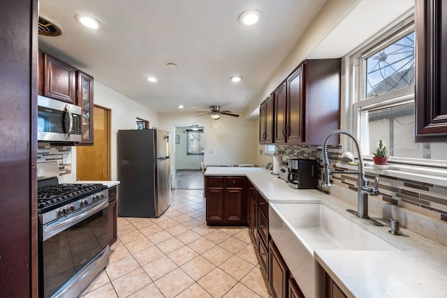 kitchen featuring light tile patterned floors, appliances with stainless steel finishes, a sink, and recessed lighting