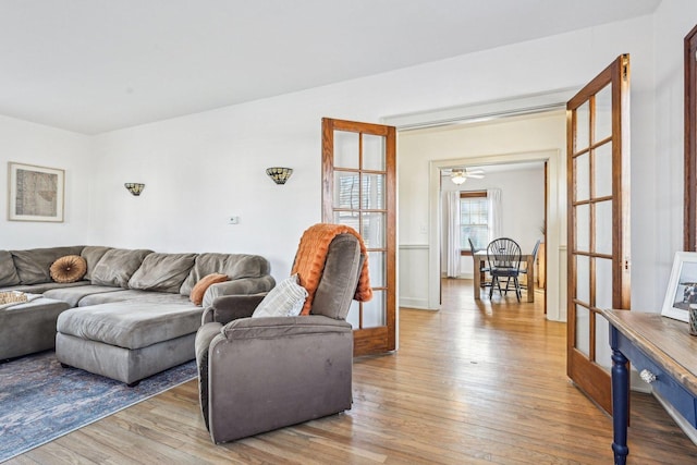 living room with light wood-style floors and french doors