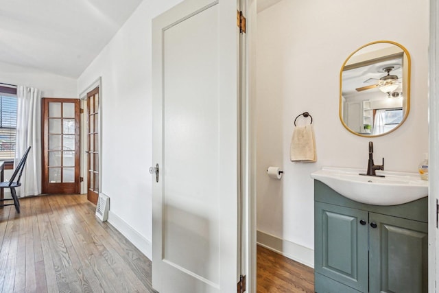 bathroom featuring visible vents, vanity, baseboards, and hardwood / wood-style flooring