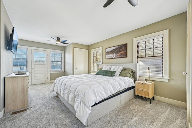 carpeted bedroom with ceiling fan and baseboards