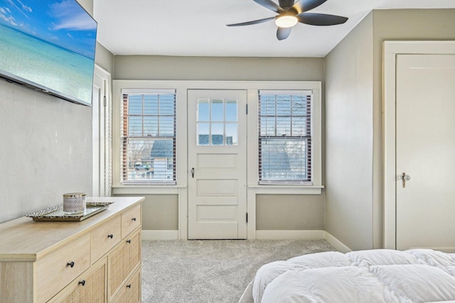 bedroom featuring light carpet, ceiling fan, and baseboards