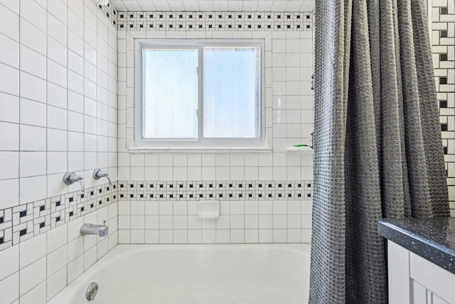 bathroom with a washtub and a shower with shower curtain