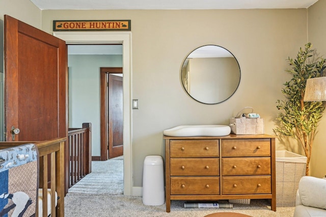 bedroom with baseboards and light colored carpet