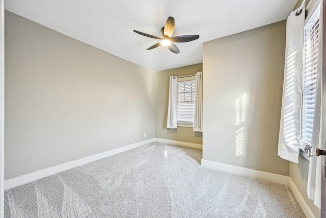 unfurnished room featuring a ceiling fan, baseboards, and carpet flooring