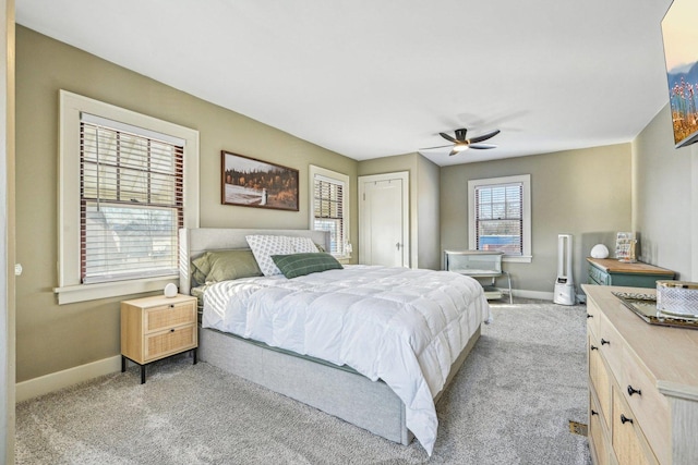 bedroom with baseboards, ceiling fan, and light colored carpet