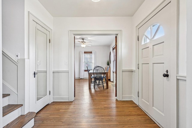 entrance foyer with stairs, baseboards, and hardwood / wood-style flooring