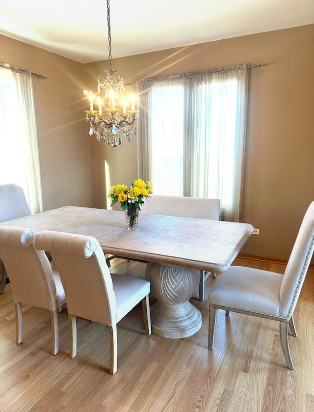 dining area featuring a chandelier and light wood-style floors