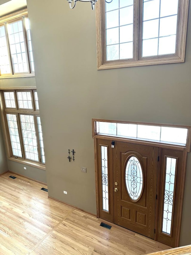 entryway with visible vents, plenty of natural light, and wood finished floors