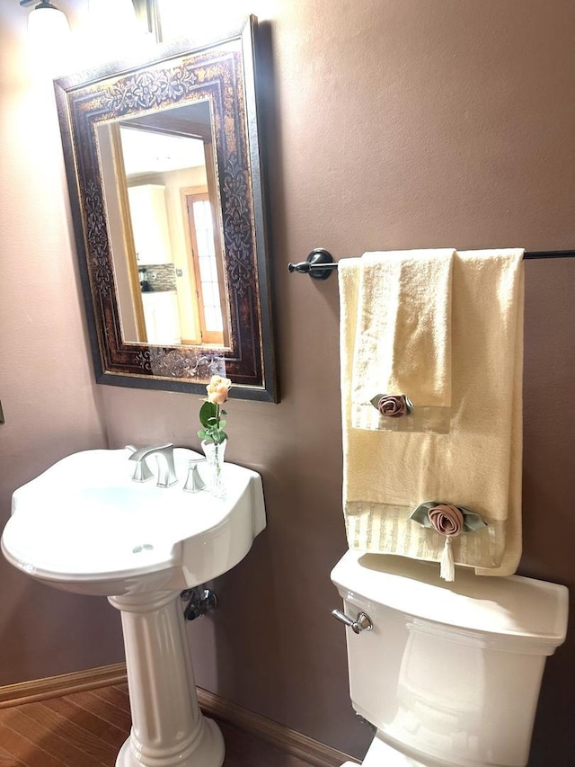 bathroom featuring baseboards and wood finished floors