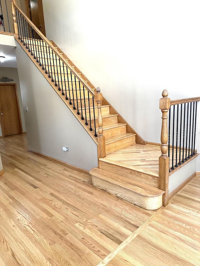 stairway with wood finished floors