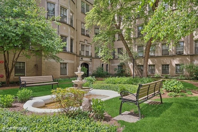 view of home's community featuring a lawn