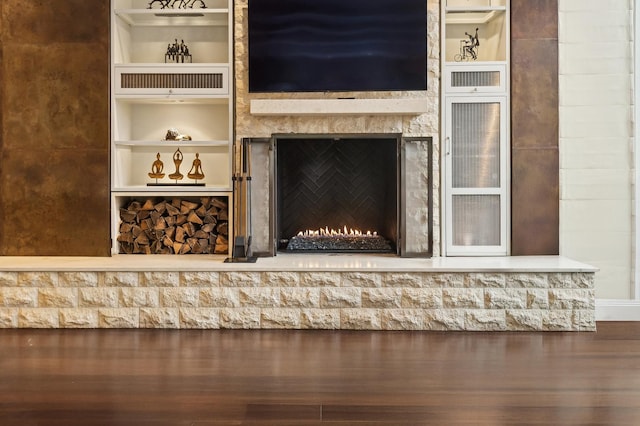 room details featuring a warm lit fireplace