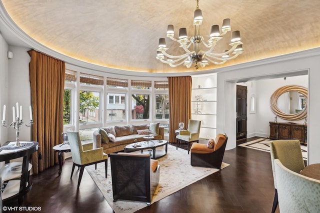 interior space featuring built in shelves, baseboards, vaulted ceiling, a tray ceiling, and an inviting chandelier