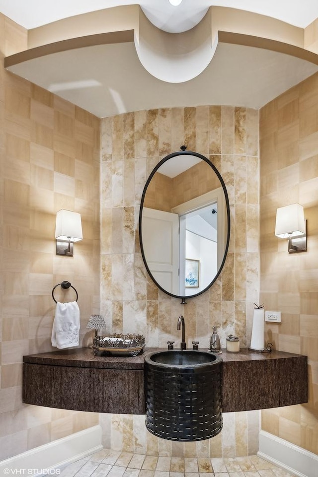 bathroom featuring tasteful backsplash and tile walls