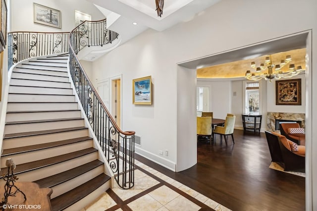 staircase with visible vents, baseboards, wood finished floors, a chandelier, and recessed lighting