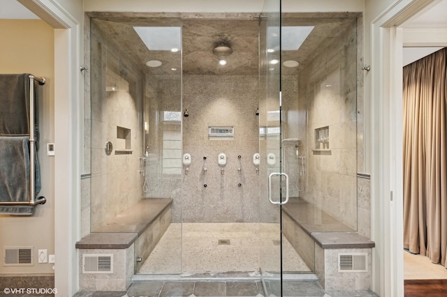 bathroom featuring a stall shower and visible vents