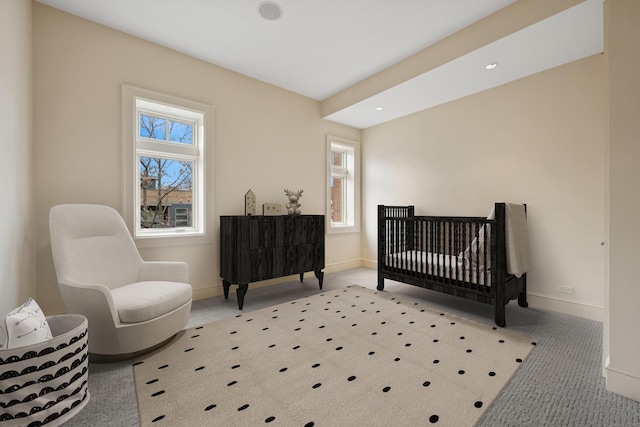 carpeted bedroom featuring a crib, baseboards, and recessed lighting