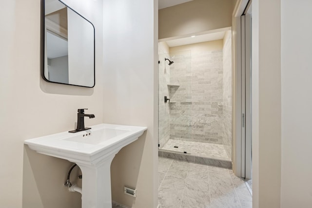 full bathroom featuring marble finish floor and a stall shower