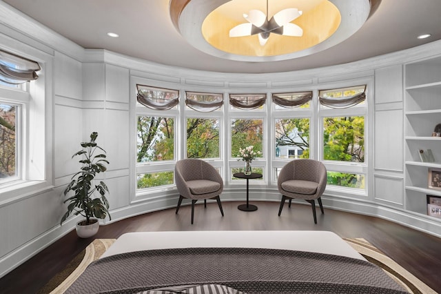 sunroom / solarium with a chandelier