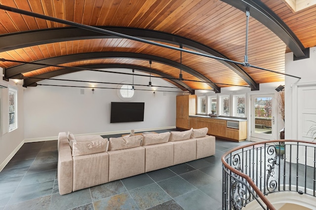 living room featuring wooden ceiling, lofted ceiling with skylight, baseboards, and stone tile flooring