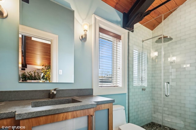 bathroom featuring lofted ceiling with beams, toilet, a stall shower, wood ceiling, and vanity