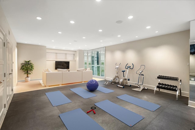 exercise room with recessed lighting and baseboards