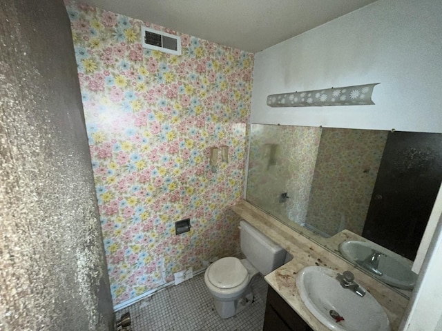 half bath featuring tile patterned flooring, visible vents, vanity, and toilet