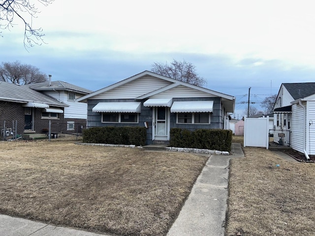 bungalow-style home featuring a front yard