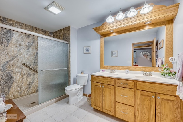 full bathroom with double vanity, a shower stall, and a sink