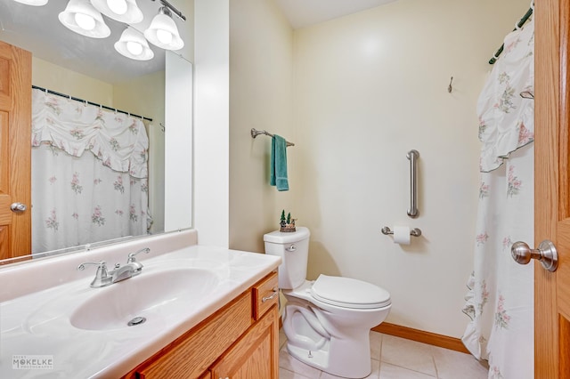 bathroom featuring baseboards, vanity, toilet, and tile patterned floors