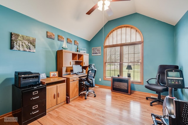 office area featuring light wood-style floors, lofted ceiling, ceiling fan, and baseboards