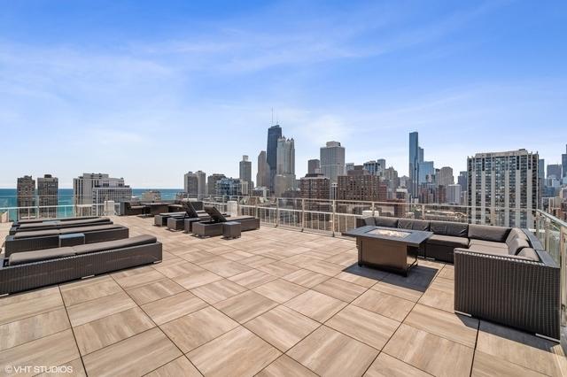 view of patio / terrace featuring a view of city and an outdoor living space with a fire pit