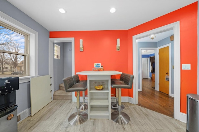 dining space with recessed lighting, light wood-type flooring, and baseboards