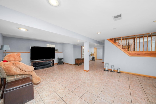 living area featuring light tile patterned floors, baseboards, and visible vents